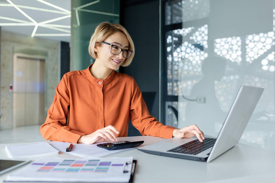Person sitting on laptop smiling